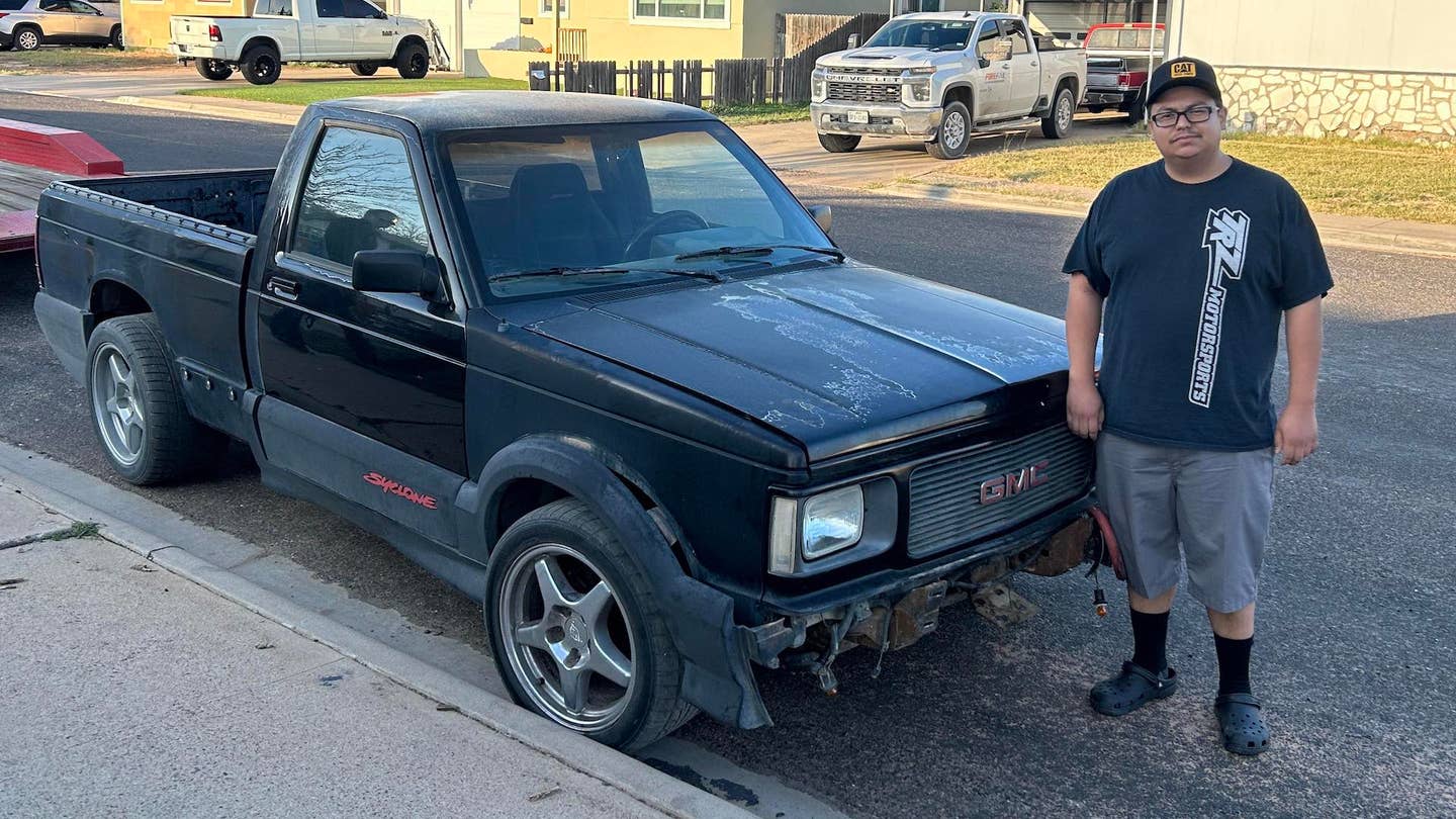 A GMC Syclone with its owner standing next to it